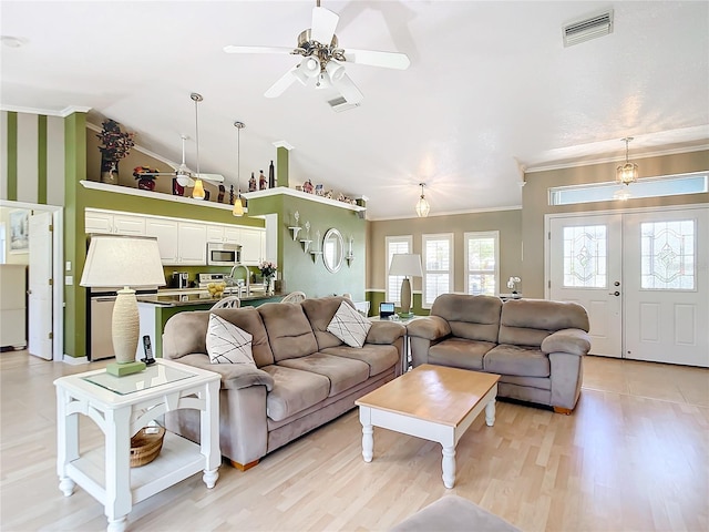 living room featuring ornamental molding, light hardwood / wood-style flooring, and ceiling fan