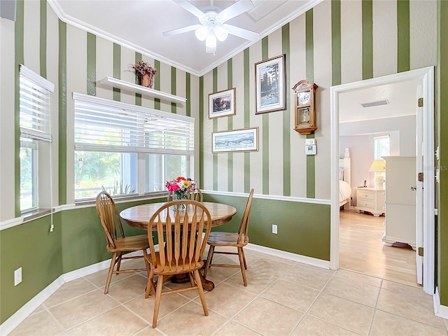 dining space with light hardwood / wood-style floors, crown molding, and ceiling fan