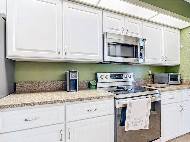 kitchen featuring white cabinetry and stainless steel appliances