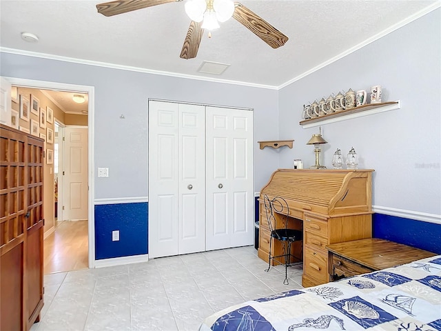 bedroom with ceiling fan, light tile patterned flooring, a closet, and ornamental molding