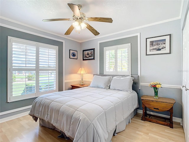 bedroom with ornamental molding, light wood-type flooring, and ceiling fan