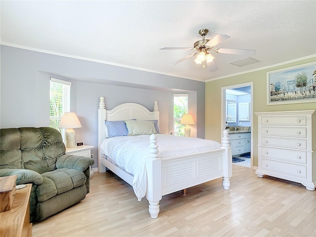 bedroom featuring ensuite bath, sink, light hardwood / wood-style floors, ceiling fan, and ornamental molding