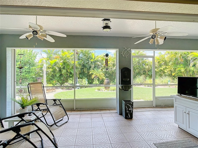 unfurnished sunroom with a healthy amount of sunlight and ceiling fan