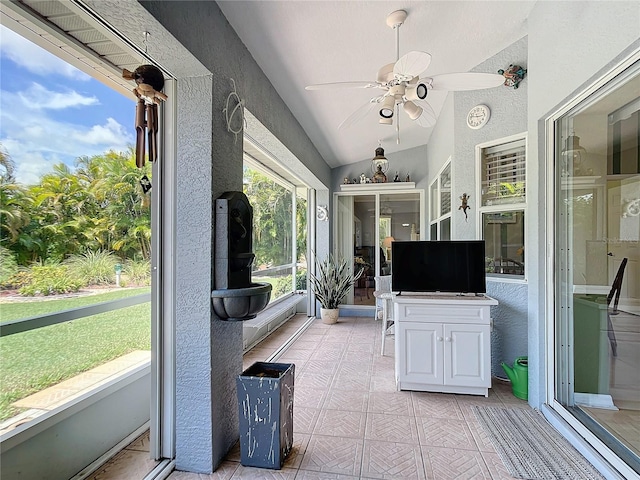 unfurnished sunroom featuring vaulted ceiling and ceiling fan