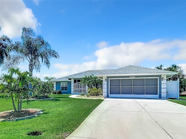 ranch-style house with a garage and a front yard