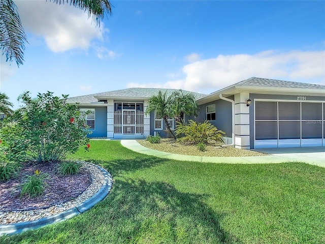 view of front of house featuring a garage and a front lawn