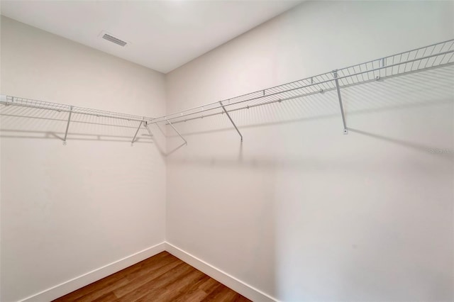 spacious closet featuring hardwood / wood-style floors