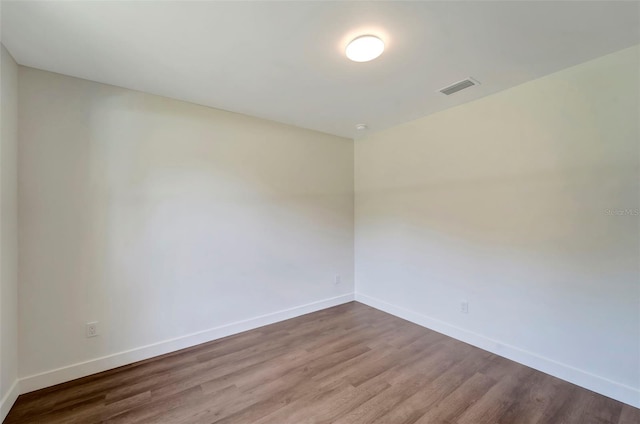 unfurnished room with hardwood / wood-style flooring