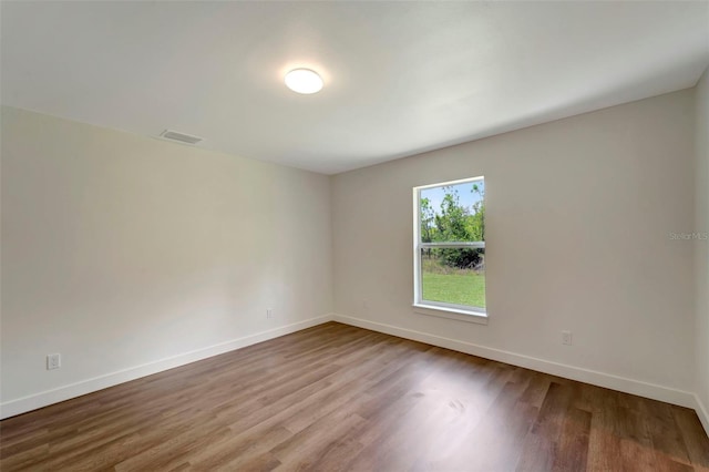 spare room with hardwood / wood-style flooring