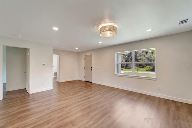 spare room featuring light hardwood / wood-style flooring