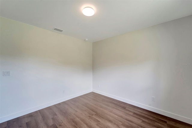 unfurnished room with hardwood / wood-style flooring