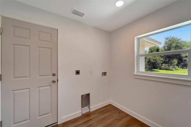 washroom featuring hardwood / wood-style flooring, hookup for an electric dryer, and washer hookup