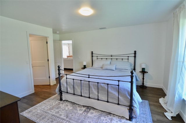 bedroom with dark wood-type flooring