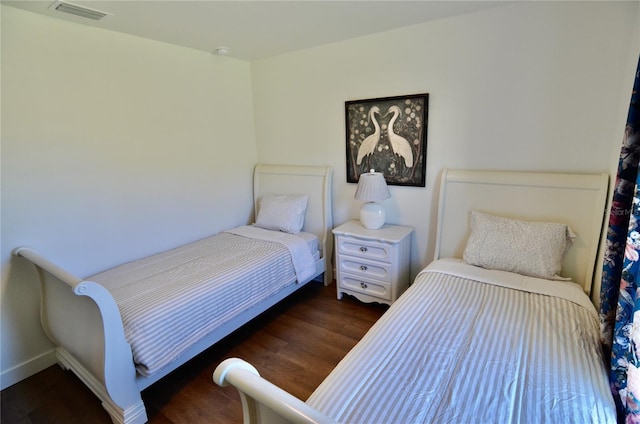 bedroom featuring dark hardwood / wood-style flooring