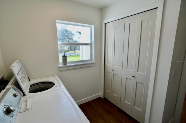 clothes washing area with dark wood-type flooring and washer and clothes dryer