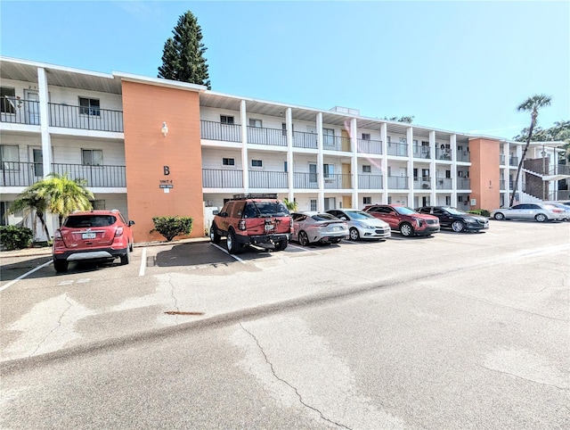 view of building exterior with uncovered parking