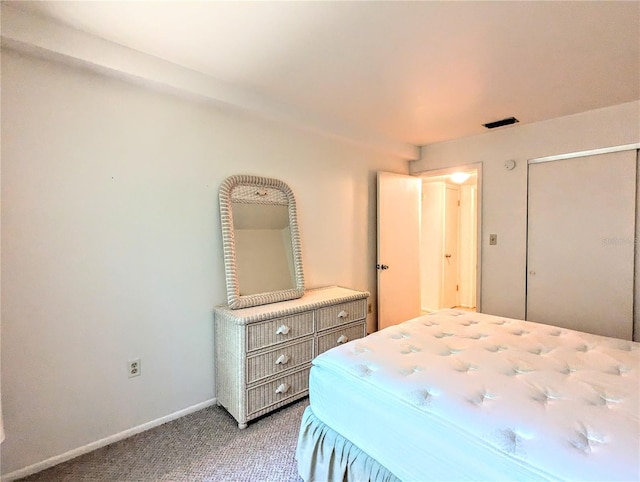 carpeted bedroom featuring visible vents and baseboards