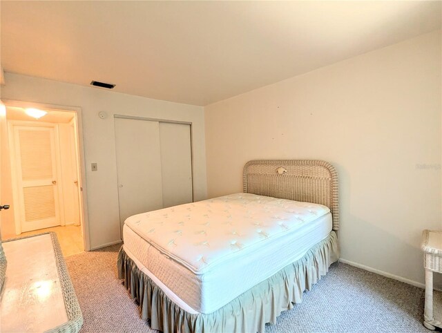 carpeted bedroom with a closet