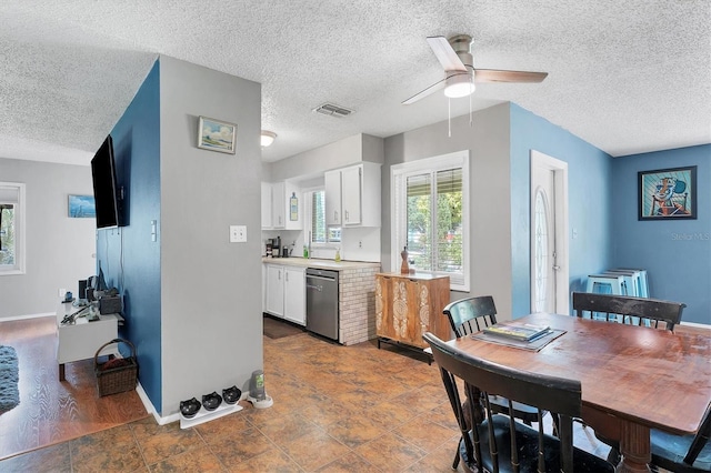 dining area with tile patterned floors, a textured ceiling, and ceiling fan