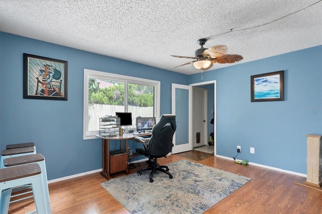 office space with a textured ceiling, hardwood / wood-style flooring, and ceiling fan