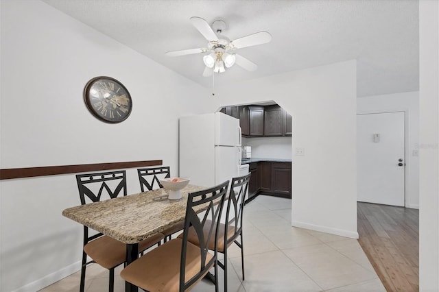 dining area with ceiling fan and light hardwood / wood-style floors