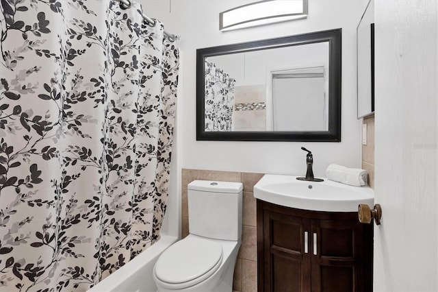 full bathroom featuring vanity, shower / tub combo, tile walls, and toilet