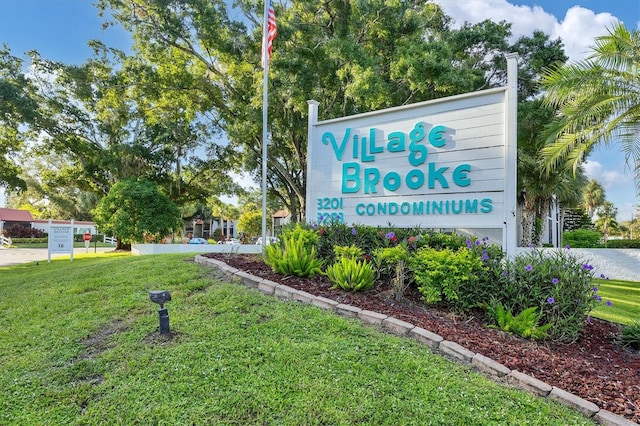 community / neighborhood sign with a lawn