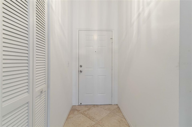 hall featuring light tile patterned flooring