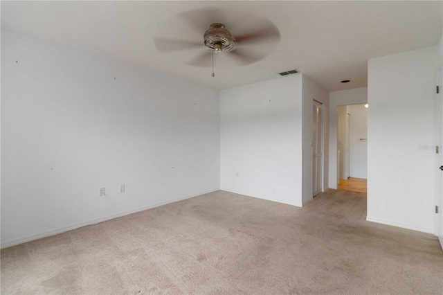 carpeted empty room with ceiling fan