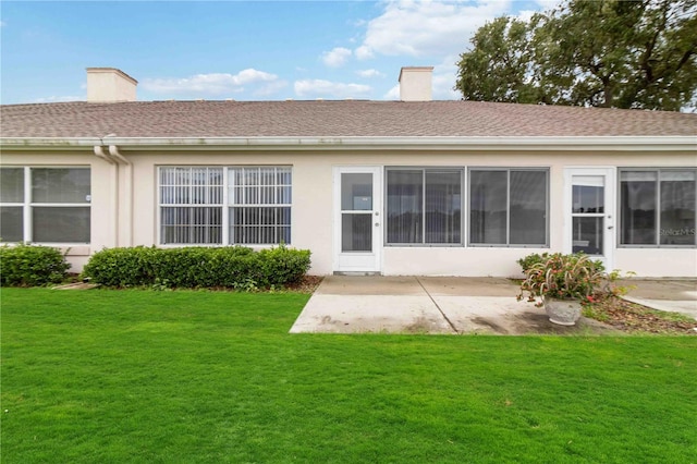 back of property featuring a yard and a patio area