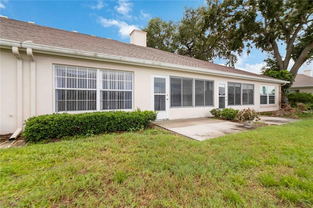 rear view of property with a yard