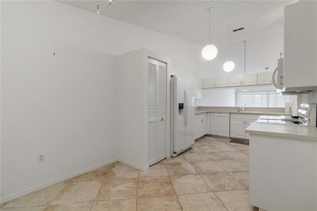 kitchen with white cabinetry, hanging light fixtures, white appliances, and light tile patterned floors