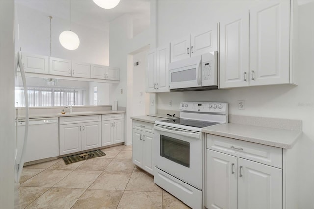 kitchen featuring light tile patterned flooring, decorative light fixtures, white appliances, and white cabinets