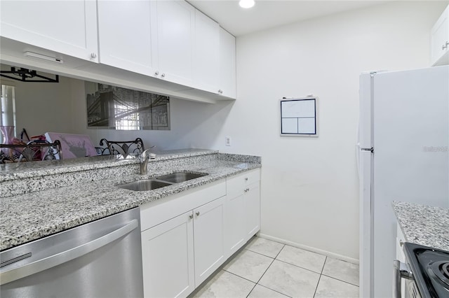 kitchen featuring white fridge, stainless steel dishwasher, white cabinets, sink, and light stone countertops