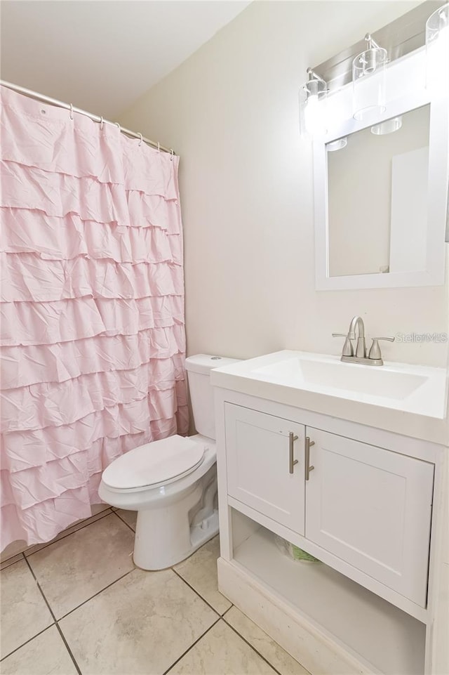 bathroom with tile patterned floors, toilet, and vanity