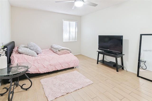 bedroom with light wood-type flooring and ceiling fan