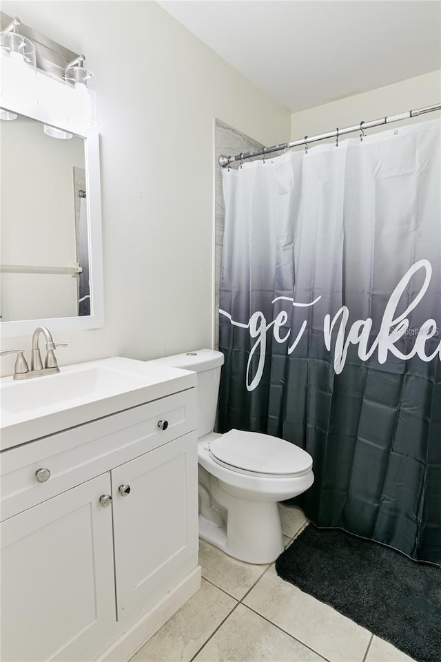 bathroom featuring tile patterned floors, toilet, and vanity