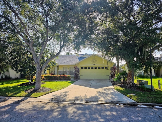 ranch-style house featuring a garage and a front yard