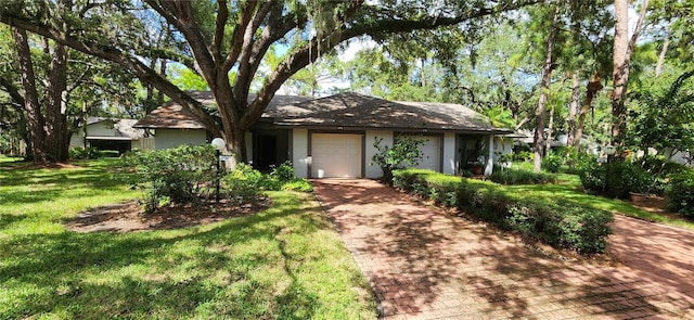 ranch-style house featuring a front yard and a garage