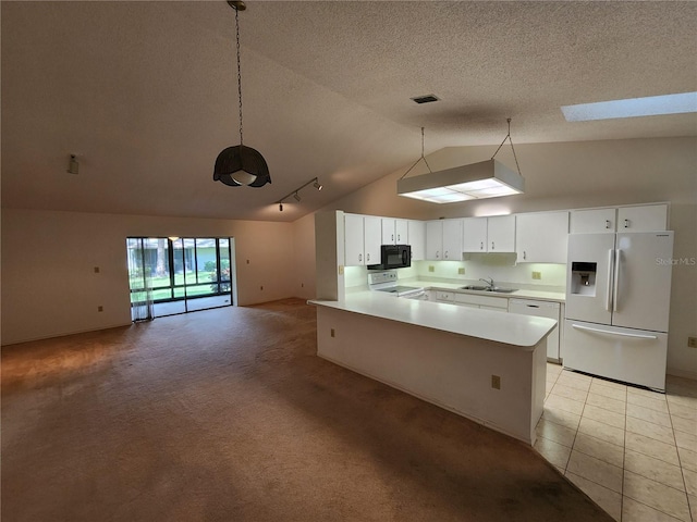 kitchen with white appliances, light carpet, sink, white cabinetry, and lofted ceiling with skylight