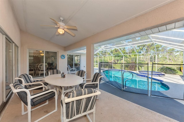 view of swimming pool with ceiling fan, an in ground hot tub, a patio, and glass enclosure