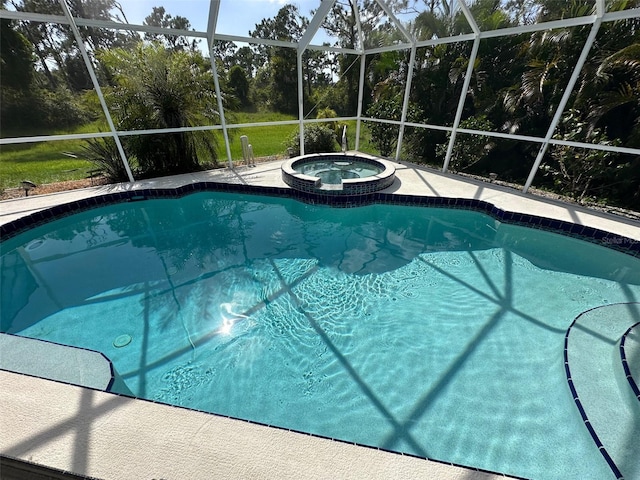 view of pool with an in ground hot tub and glass enclosure