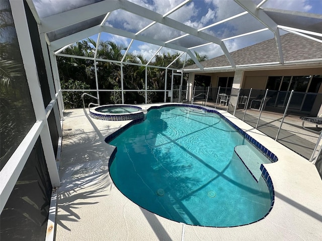 view of swimming pool featuring a lanai, an in ground hot tub, and a patio