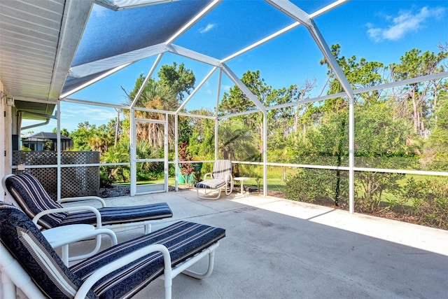 view of patio featuring glass enclosure