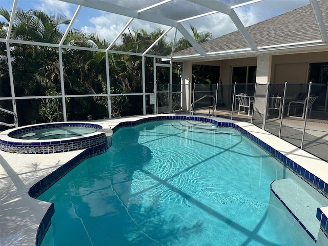 view of swimming pool with glass enclosure, an in ground hot tub, and a patio