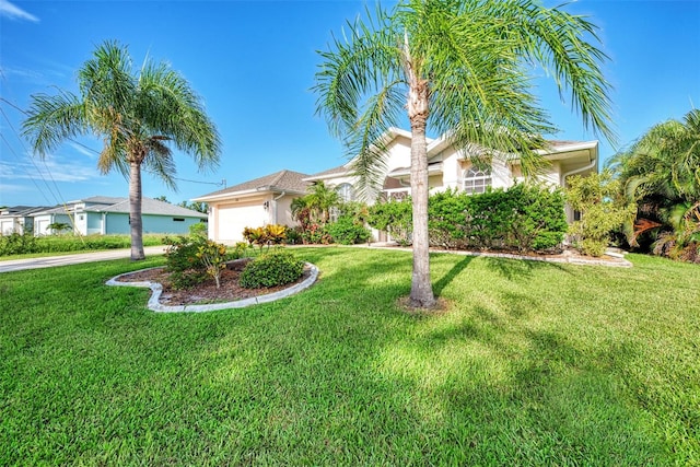 view of front of house with a front yard and a garage