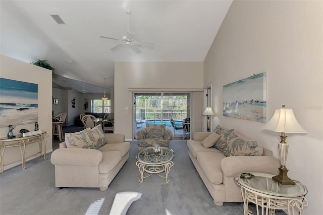 living room featuring carpet flooring, ceiling fan, and vaulted ceiling