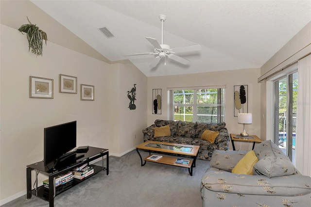 living room with carpet floors, vaulted ceiling, ceiling fan, and a healthy amount of sunlight