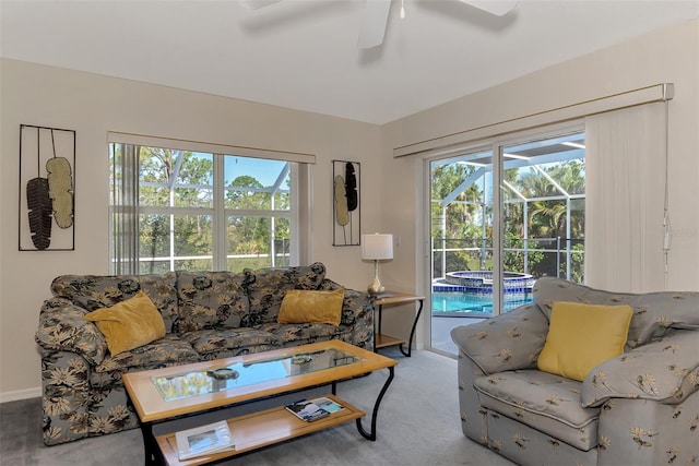 carpeted living room featuring plenty of natural light and ceiling fan