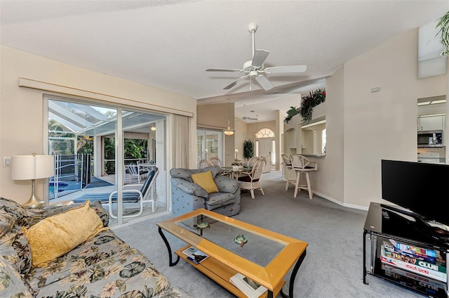 carpeted living room with ceiling fan